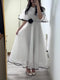 White Chiffon Maxi Dress With Black Trim And Floral Accent